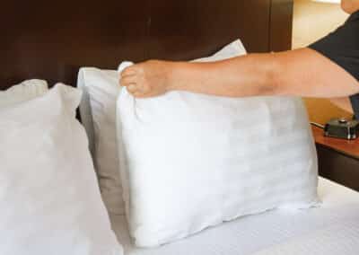 First Choice Inn's house keeping puffing the pillow