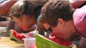 Green River Melon Days | First Choice Inn at the Swell Green River, Utah Kids Eating Melon in a Contest During Green River Melon Days